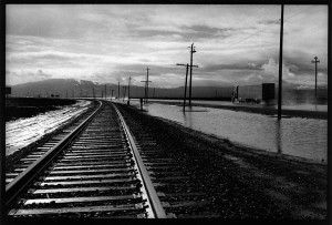 California State Route 183.  I’ve traveled this road many, many times. In the rainy season the water puddles up between the road and the railroad tracks. Add the off kilter telephone poles, a semi-truck heading south and a cloudy sky and it has some visual appeal.  This was the first time I actually made a special trip to CA 183 for photographs. It was a bit more difficult to photograph than it looked zooming by at 60 MPH.  I spent a fair bit of time looking, waiting for the rain to ease up and photographing at different puddles.  Call this a sketch