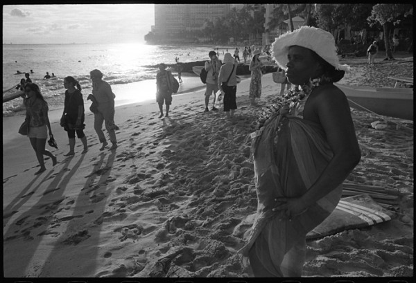 Agnus was standing near me. I kept looking her way thinking how great she looked in her hat, leis and pink and purple dress with the sweet evening light. I wanted to take her photo but I didn't want to be rude. She pulled out a Kodak disposable camera and asked me to take some photos of her. I asked if I could take a few of her with my camera. This is one of them. 