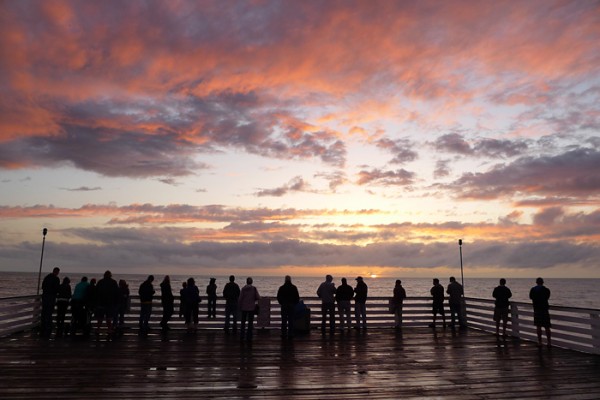 Watching the sunset is both a cliche and a big part of beach culture. It had been grey and rainy all afternoon. Just before sunset the rain stopped, the sun popped out and folks made a beeline to the pier. I couldn't resist a snapshot.