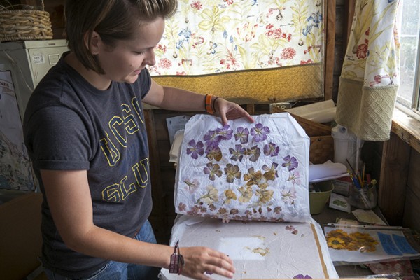 Rosalee, a UCSC intern from the Psychology Department, works with dried flowers at the Homeless Garden Project.