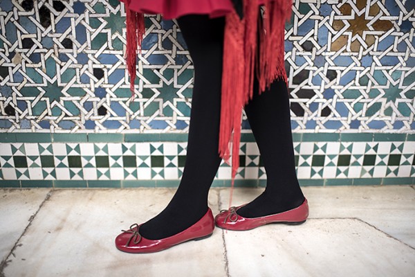 Fashion forward at the fort. Sevilla's Alcázar, an architectural wonder built in the 1300's, serves as a backdrop for red shoes.