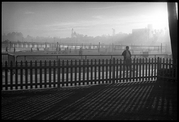 This scene caught my eye. The hazy light, vertical and horizontal lines and the lone figure relaxing against the rail make an interesting composition.